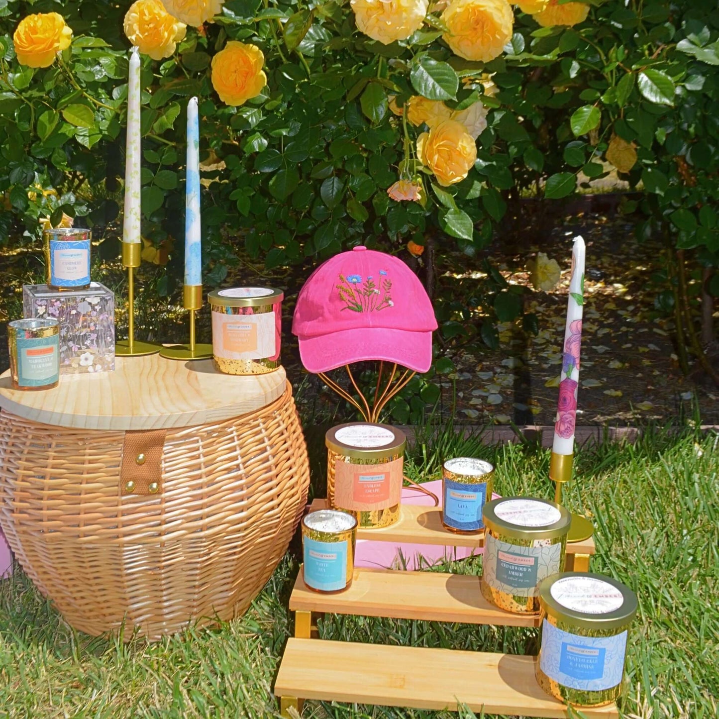 Thread & Ember Bergamot & Rosemary candle styled with hand-embroidered floral hats for a feminine touch.