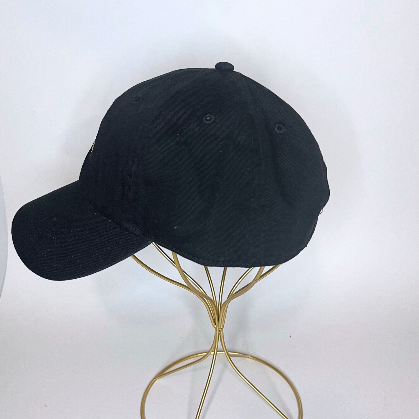 Left side view of the black Aries constellation baseball cap with a curved visor and adjustable strap.