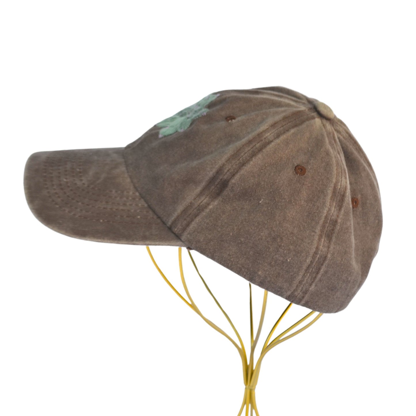 Left side of brown baseball hat featuring plant-inspired succulent embroidery.
