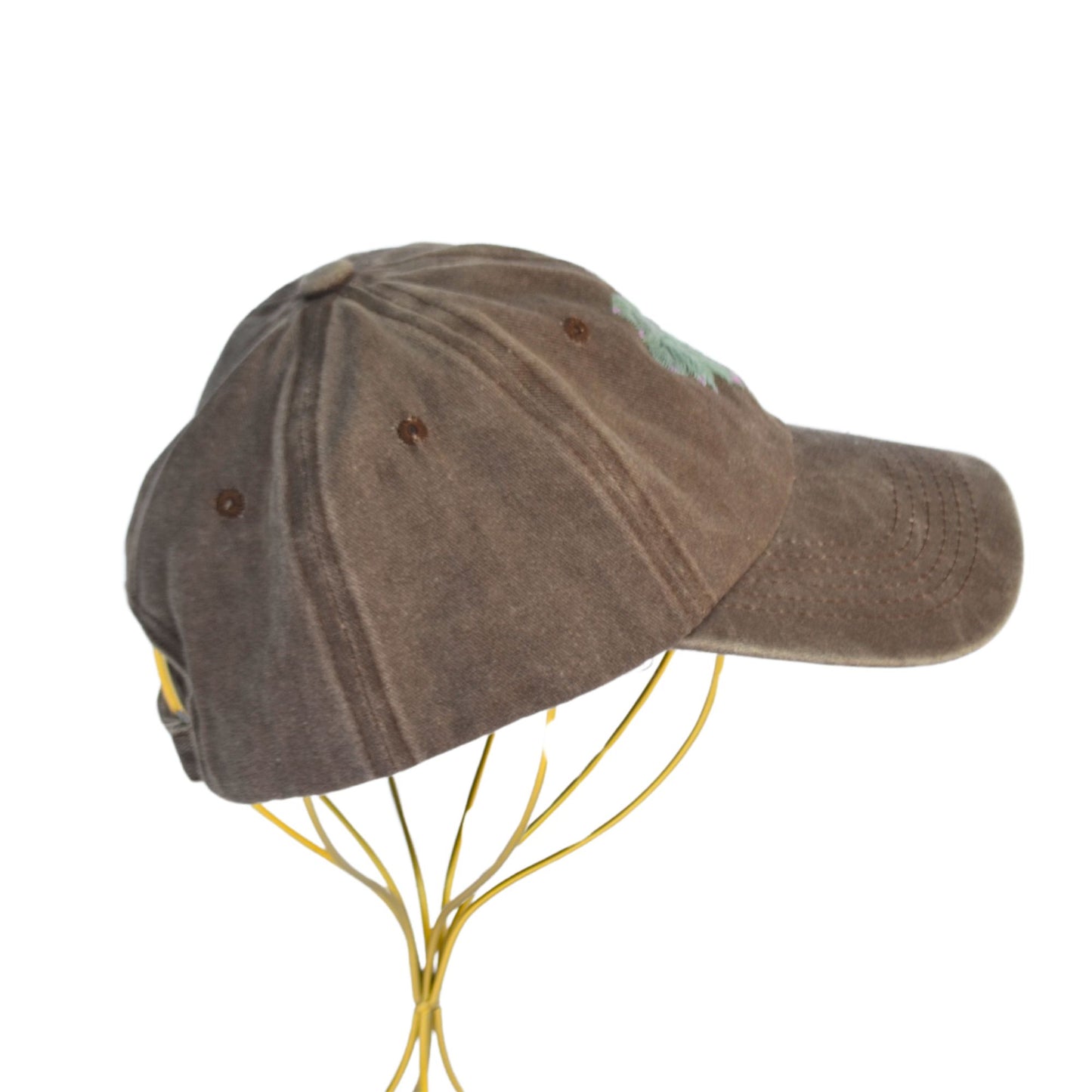 Right side of adjustable brown baseball hat with unique succulent design.