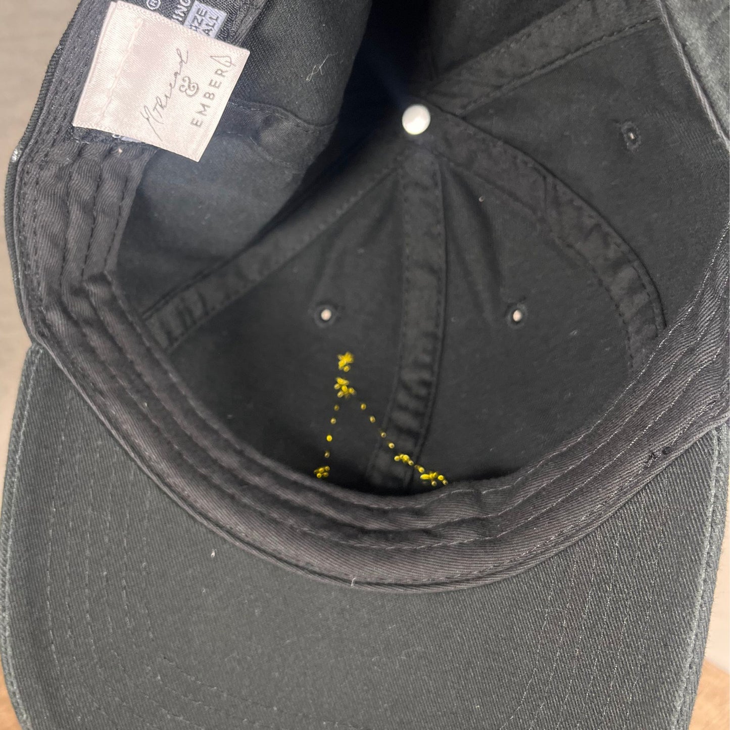 Inside view of the black Cancer hat with constellation embroidery detail