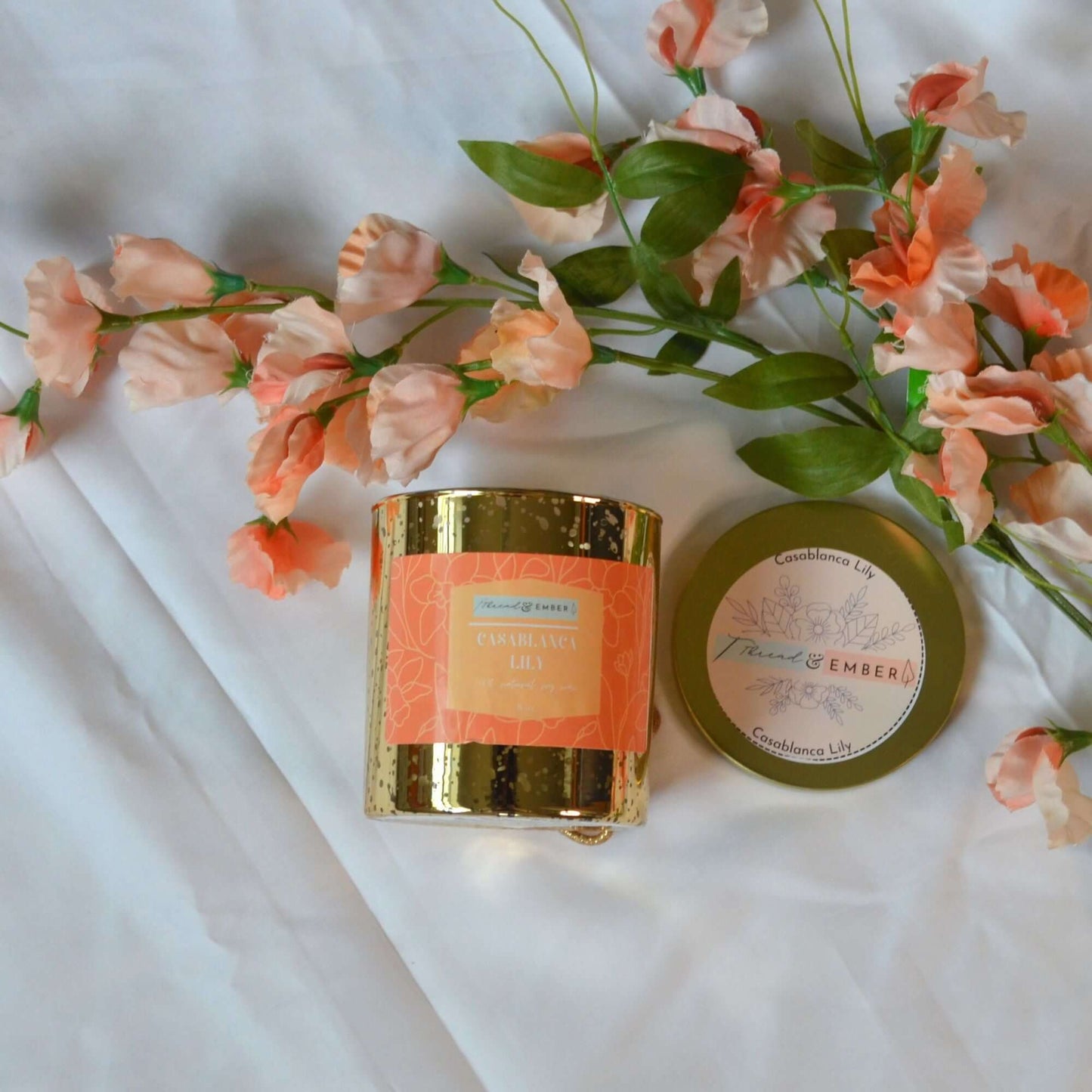 Casablanca Lily Candle by Thread & Ember in a luxurious gold mercury glass jar with floral decor.