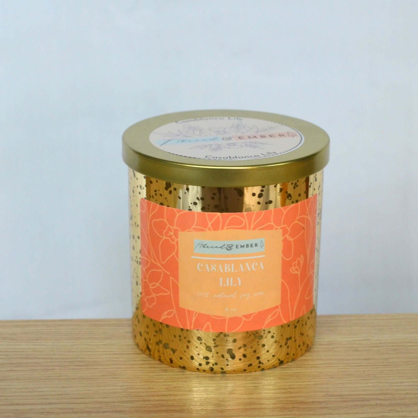 Casablanca Lily candle in an elegant gold mercury jar with floral pink label.