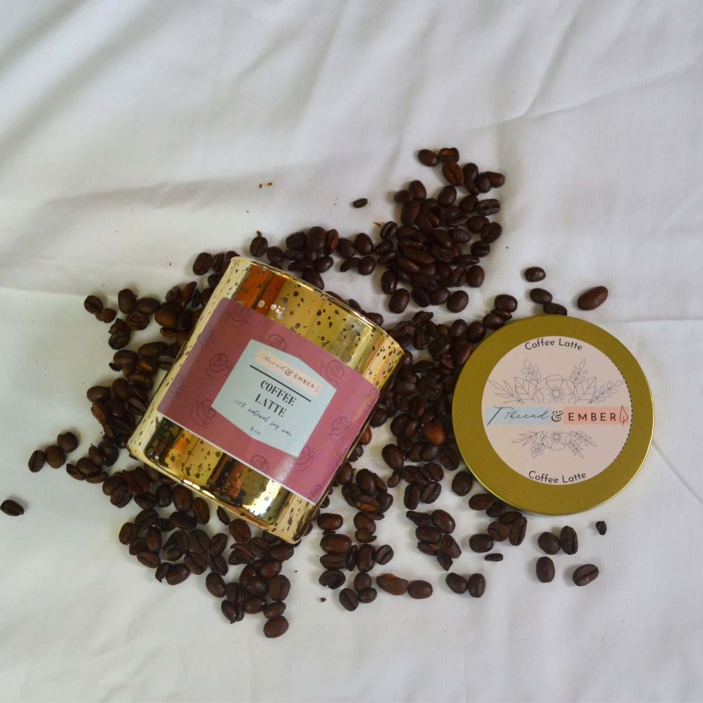 Coffee Latte candle in gold mercury jar with scattered coffee beans.