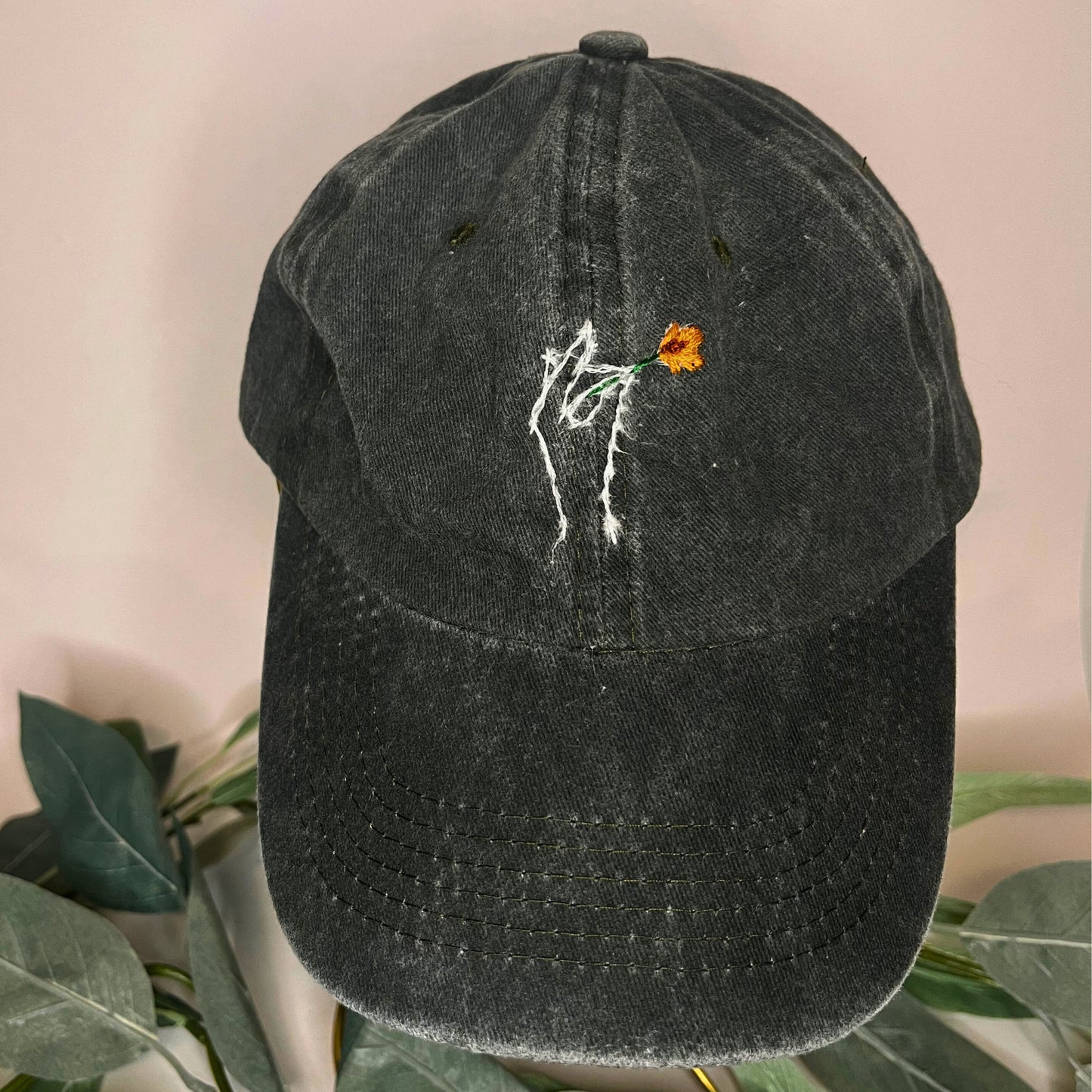 Front view of a green baseball cap with golden poppy embroidery, featuring vibrant details and nature-inspired design by Thread & Ember.