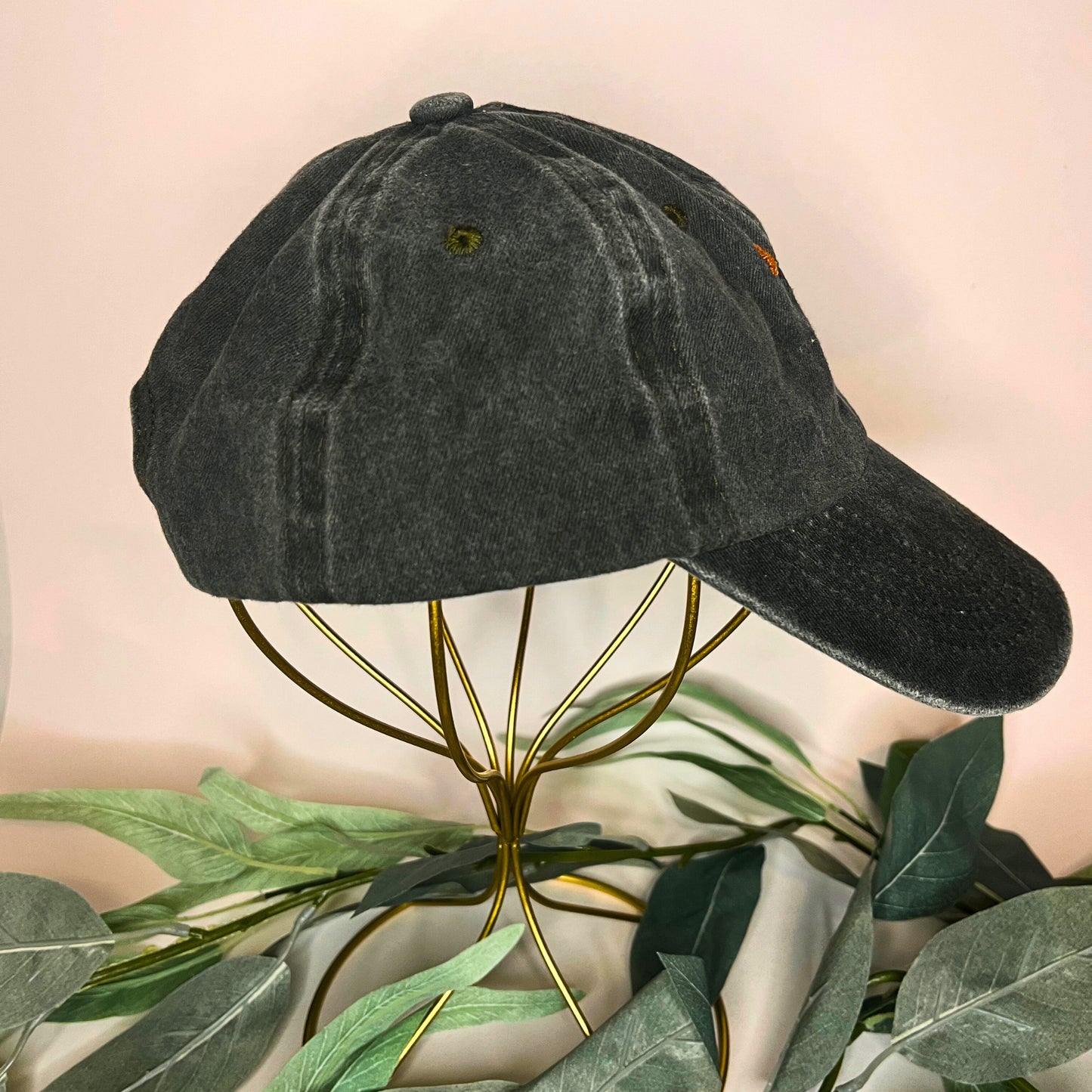 Right side view of a green baseball cap featuring subtle golden poppy embroidery.