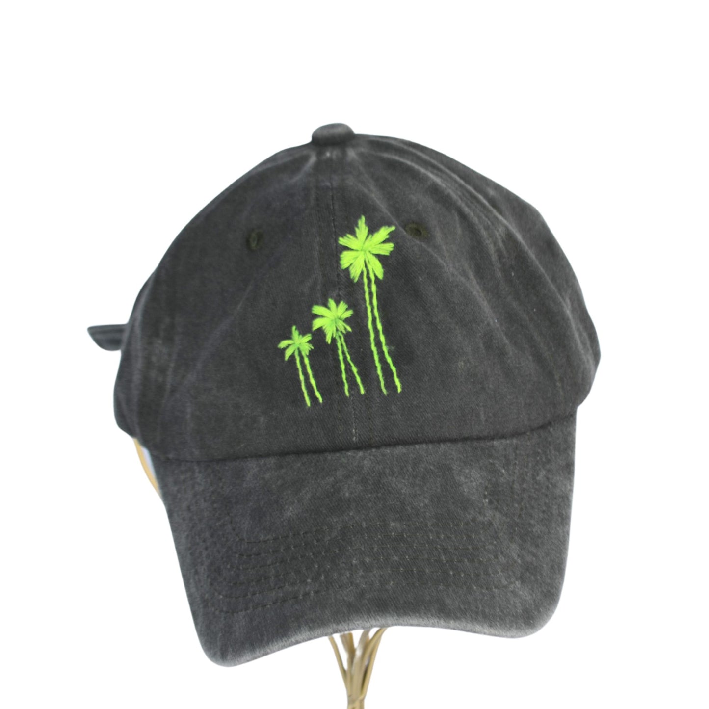 Front view of green hat showcasing neon palm tree embroidery.