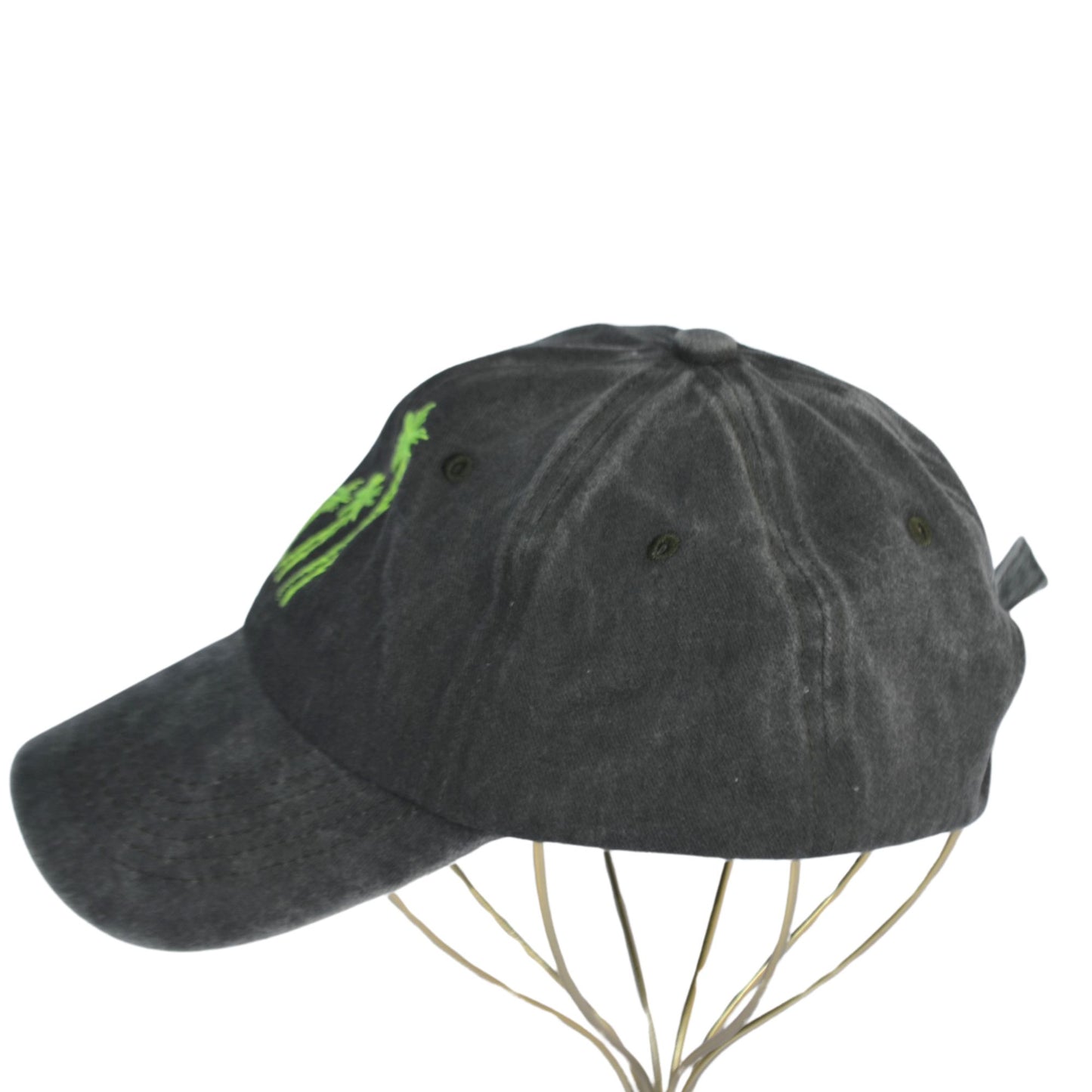 Left-side view of green hat featuring neon palm tree design.