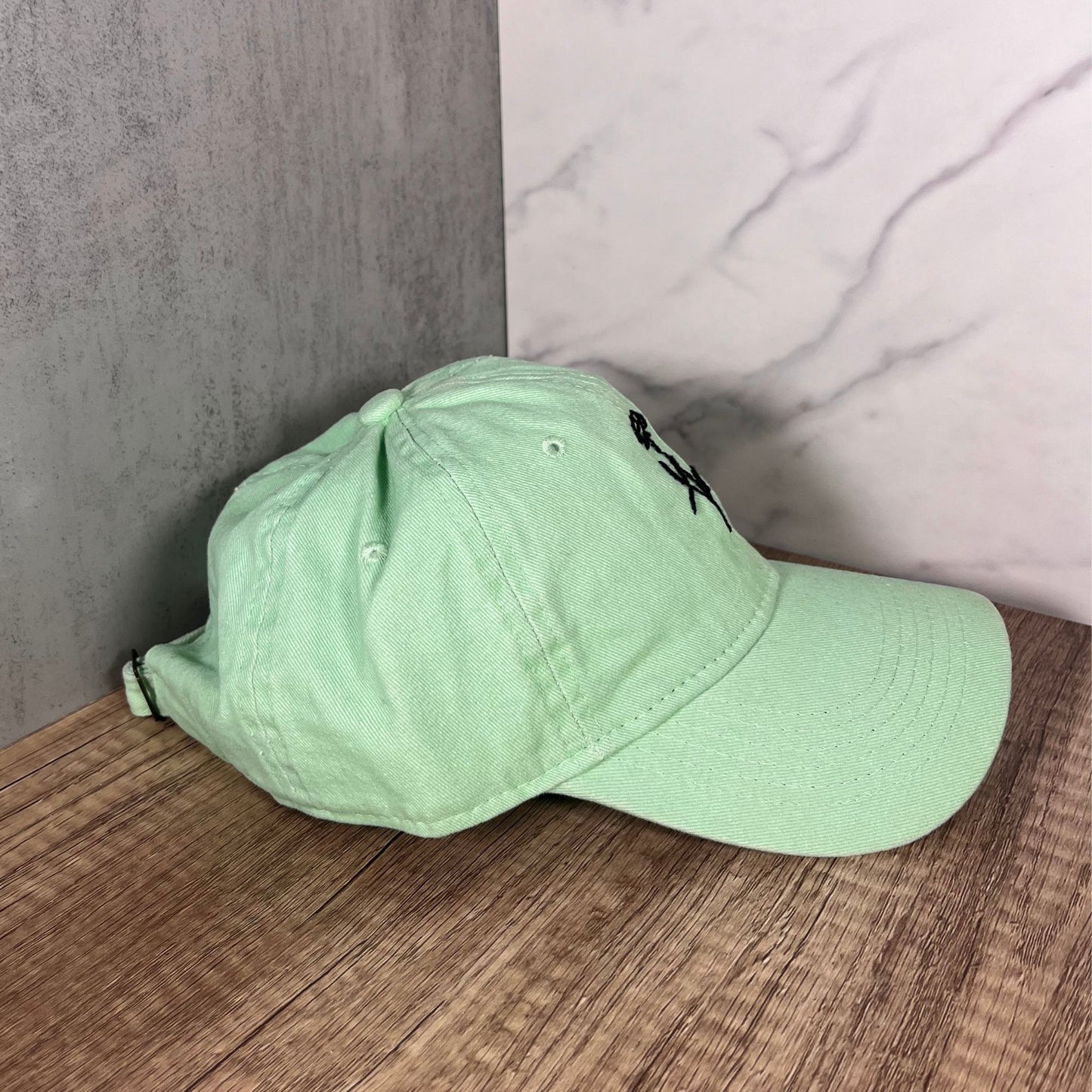 Right-side view of a mint green cap highlighting its clean design and curved brim.
