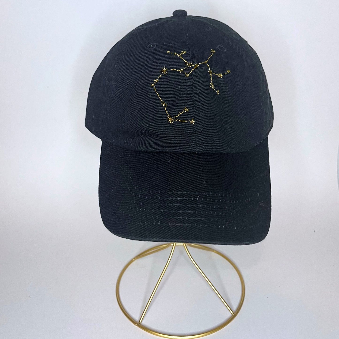 Black Sagittarius constellation hat featuring intricate yellow embroidery on a stylish design.
