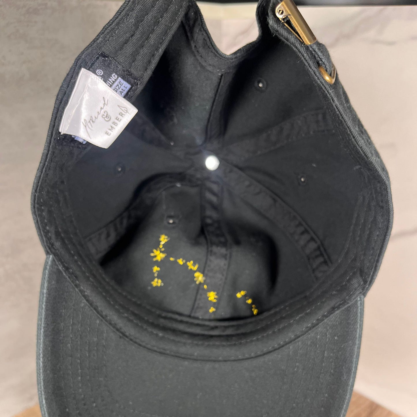 Inside view of a Scorpio zodiac constellation hat showing detailed embroidery on the inner fabric.