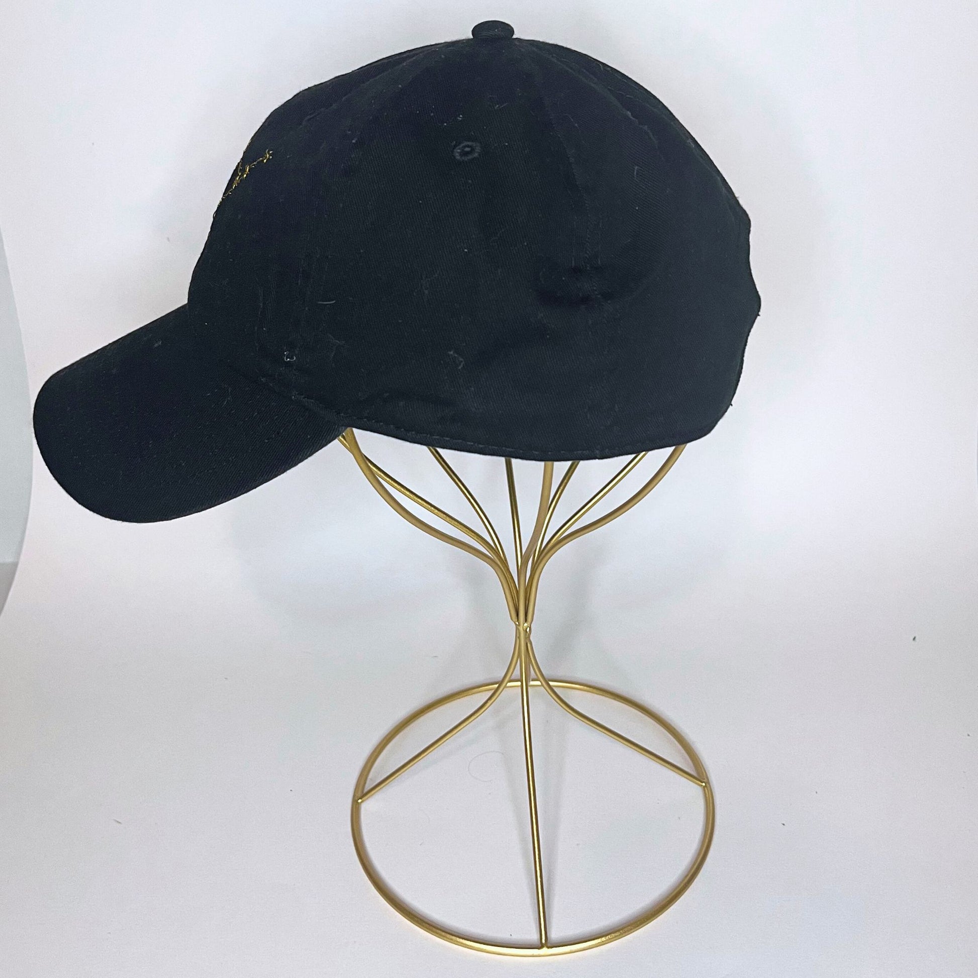 Side view of a black Virgo constellation cap featuring adjustable back strap with brass buckle.