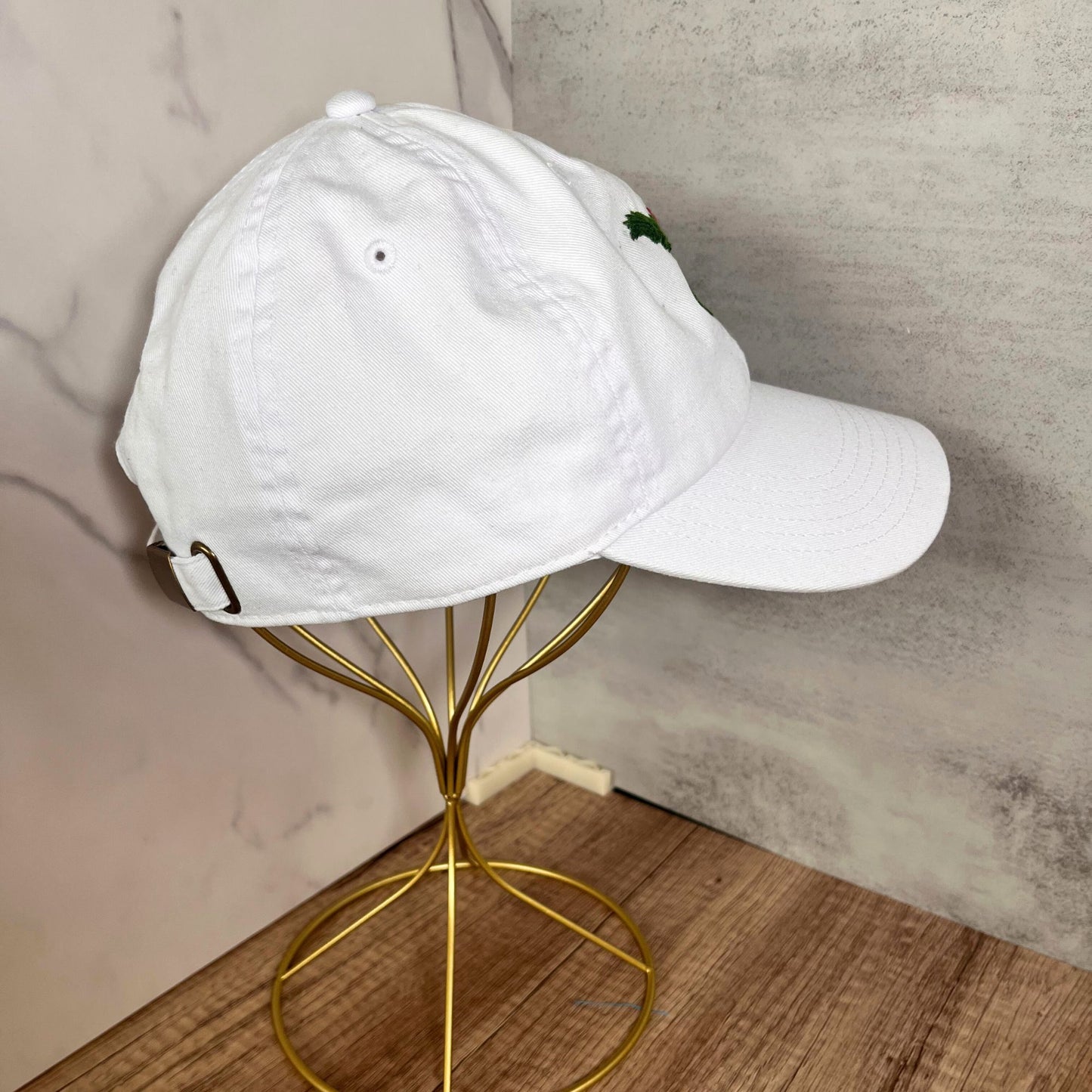 Right-side view of a white hat with festive embroidery, highlighting the craftsmanship.