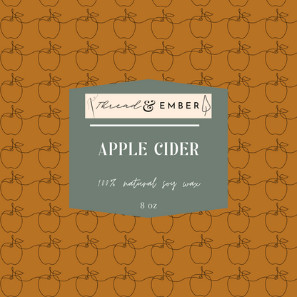 Close-up of the Thread & Ember Apple Cider Candle label, highlighting its 100% natural soy wax composition.