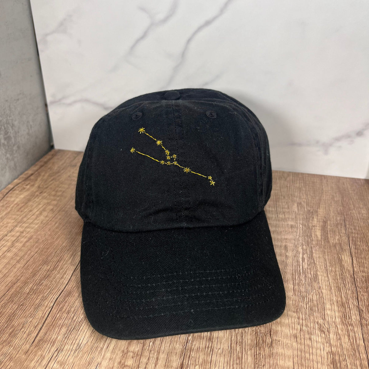 Thread Constellation Front view of a black Taurus constellation embroidered cap, showcasing ...